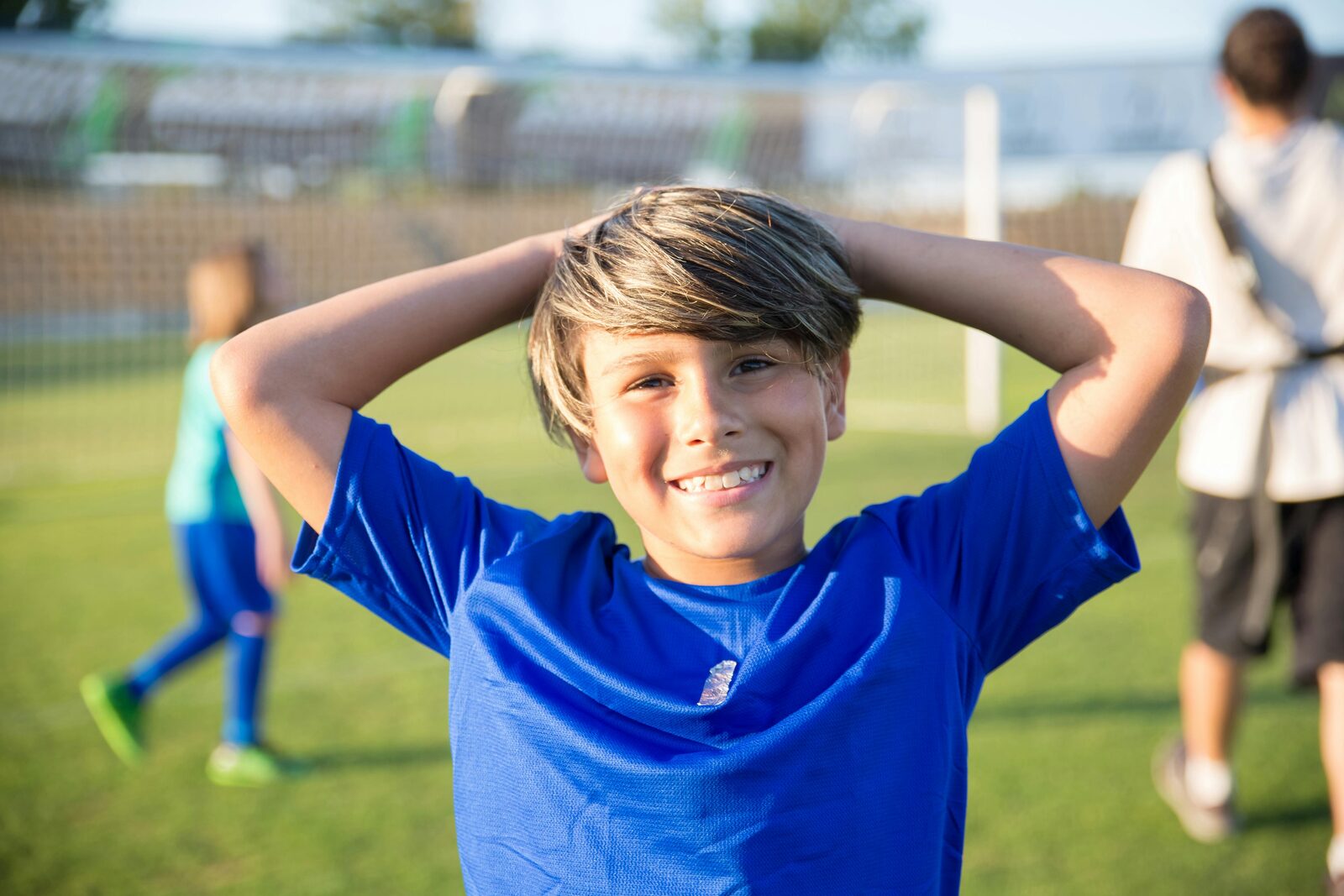 Boy of around twelve holding a football, photographed in portrait